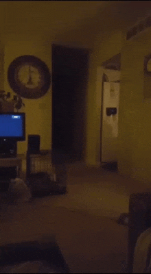 a person standing in a dark room with a green button that says " g-h moderator "