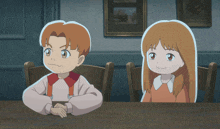 a boy and a girl are sitting at a table with their hands on the table