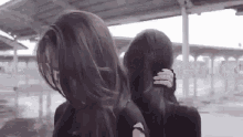 a couple of women are standing next to each other .