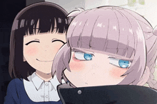 two anime girls are posing for a picture and one is smiling and the other is making a funny face