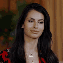 a woman wearing a necklace that says ' dani ' on it