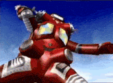 a red robot with a t on the back of it