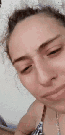 a close up of a woman 's face with a sad look on her face
