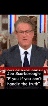 a man in a suit and tie is giving a speech