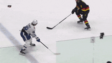 a hockey game is being played in front of a save on foods banner