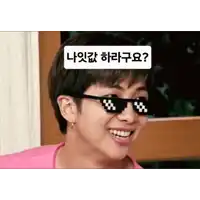 a young man wearing sunglasses with a foreign language sticker on his head .