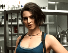 a woman in a blue tank top stands in a room with a vaccine solution bottle in the background