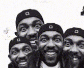 a group of men with beanies on their heads are making funny faces .
