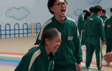 a man and a woman are laughing together and the man has the number 007 on his jacket