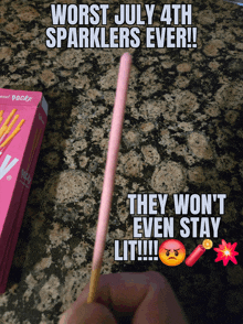a person is holding a pink stick that says " worst july 4th sparklers ever "