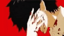a person is covering their face with their hand .