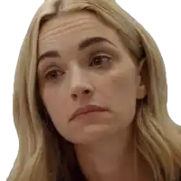 a close up of a blonde woman 's face with a serious look on her face