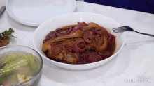 a plate of food with a fork on a table with the words made in animatica on the bottom right