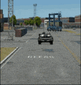 a tank is driving down a road with the letter c on the side