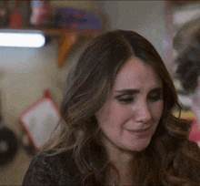 a woman is crying with a tear running down her cheek
