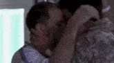 a man in a military uniform is kissing another man