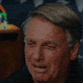 a close up of an older man 's face with a blurred background