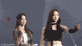 two women are standing next to each other and one of them has the number 16 on her chest
