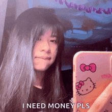 a girl taking a selfie with a hello kitty phone case