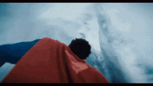 a man in a superman cape flies through the air
