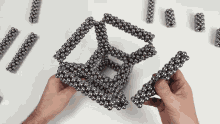 a person is holding a bunch of metal balls in their hand