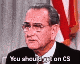 a man in a suit and tie is saying you should get on cs