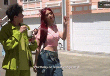 a man and a woman are walking down a street and the woman is wearing headphones and dancing .