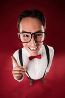a man wearing glasses and suspenders is pointing