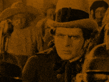 a man wearing a top hat stands in a crowd