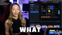 a woman is sitting in front of a screen that says what on it