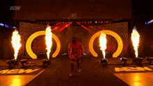 a wrestler is walking down a stage with aew written on the side