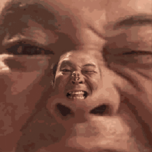 a close up of a man 's face with a reflection of another man 's face