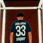 a man wearing a shirt with the number 33 on the back
