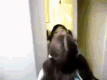 a blurry picture of a person making a funny face .