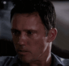 a close up of a man 's face with a dark background