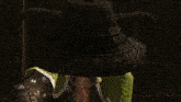 a woman in a white shirt is standing next to a man in a green outfit