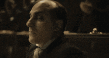 a bald man says enter the magician while making a hand gesture