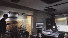 a man in a recording studio with the letter d on the bottom of the screen