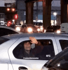 a man in a car with the word hfg on the side of it
