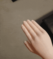 a close up of a person 's hand with a ring on it