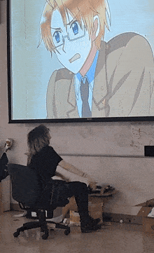 a woman sits in a chair in front of a projector screen with a picture of america on it