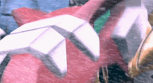 a close up of a pink and white object with a blurred background