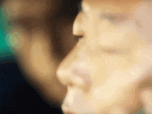 a close up of a person 's face with a blurry background