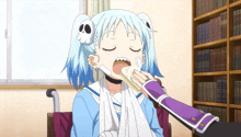 a girl in a wheelchair with a bandage on her face is eating a sandwich