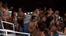 a group of people are dancing on a boat with the url gifmemes.io