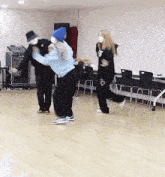 a group of people are dancing on a wooden floor