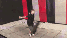 a person is jumping on a trampoline in a room .