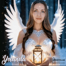 a woman with angel wings is holding a lantern in her hands