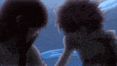 a man and a woman are touching each other 's faces with their hands