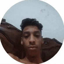 a young man taking a selfie in a round frame